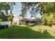 Private backyard with grassy area and screened enclosure at 3500 Sail Fish Ave, Fruitland Park, FL 34731