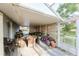 Screened patio with wicker furniture and bikes at 3500 Sail Fish Ave, Fruitland Park, FL 34731