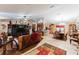 Spacious living room with hardwood floors, leather furniture, and a large entertainment center at 3500 Sail Fish Ave, Fruitland Park, FL 34731