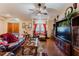 Living room with hardwood floors, leather furniture, and a large entertainment center at 3500 Sail Fish Ave, Fruitland Park, FL 34731