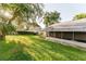 Landscaped backyard with large grassy area at 3500 Sail Fish Ave, Fruitland Park, FL 34731