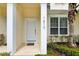 Inviting front entrance of house, featuring white door and landscaping at 1613 Retreat Cir, Clermont, FL 34714