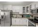 Modern kitchen with stainless steel appliances and white cabinetry at 1421 Avenue G Ne, Winter Haven, FL 33881