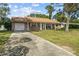 Brick ranch home with carport and lawn at 1421 Avenue G Ne, Winter Haven, FL 33881