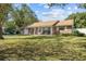 Ranch style home with a large front yard and mature trees at 1421 Avenue G Ne, Winter Haven, FL 33881