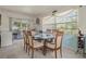 Dining area with glass-top table and six chairs, adjacent to kitchen at 1421 Avenue G Ne, Winter Haven, FL 33881