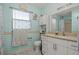 Clean bathroom with a tub shower combination and updated vanity at 1421 Avenue G Ne, Winter Haven, FL 33881