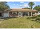 Brick ranch home with a covered porch and well-maintained lawn at 1421 Avenue G Ne, Winter Haven, FL 33881