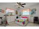 Colorful bedroom with a bed, exercise bike, and plenty of storage at 1421 Avenue G Ne, Winter Haven, FL 33881