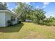 Large backyard with grassy area and mature trees at 1421 Avenue G Ne, Winter Haven, FL 33881