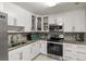 Updated kitchen featuring stainless steel appliances and granite countertops at 1421 Avenue G Ne, Winter Haven, FL 33881