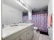 Bathroom with double vanity, shower, and patterned curtain at 9920 4Th Ave, Orlando, FL 32824