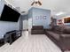 Spacious living room with two brown couches and a large TV at 9920 4Th Ave, Orlando, FL 32824