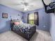 Bedroom with full-size bed and light purple walls at 9920 4Th Ave, Orlando, FL 32824