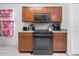 Kitchen features dark wood cabinets and stainless steel appliances at 9920 4Th Ave, Orlando, FL 32824