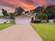 House exterior featuring a white garage door and driveway at 9920 4Th Ave, Orlando, FL 32824