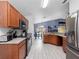 Open kitchen with stainless steel appliances and wood cabinets at 9920 4Th Ave, Orlando, FL 32824
