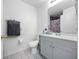 Clean bathroom with gray vanity, shower, and tile floor at 9920 4Th Ave, Orlando, FL 32824