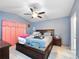 Main bedroom with a king-size bed and ceiling fan at 9920 4Th Ave, Orlando, FL 32824