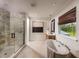 Spa-like bathroom with a freestanding tub, walk-in shower, and large window at 2944 Scout Street, Saint Cloud, FL 34771