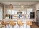 Modern kitchen with white cabinets, a large island with seating, and stylish light fixtures at 2944 Scout Street, Saint Cloud, FL 34771