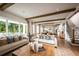 Open-concept living room with hardwood floors, comfortable seating, and views of the pool at 2944 Scout Street, Saint Cloud, FL 34771