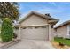 Attached garage with decorative windows and driveway at 2657 Queen Mary Pl, Maitland, FL 32751