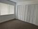 Bedroom with carpet, large closet, and window with blinds at 4815 S Texas Ave # C, Orlando, FL 32839