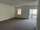 Spacious living room with carpet and sliding door to balcony at 4815 S Texas Ave # C, Orlando, FL 32839