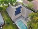 Aerial view of house showing solar panels on the roof and a screened-in pool in the backyard at 372 Hinsdale Dr, Debary, FL 32713