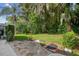 Stone patio with lush landscaping and trees at 372 Hinsdale Dr, Debary, FL 32713