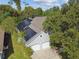 Aerial view of house with solar panels and a two-car garage at 372 Hinsdale Dr, Debary, FL 32713