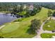 Aerial view of golf course with a lake and houses in the distance at 372 Hinsdale Dr, Debary, FL 32713