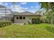 Landscaped backyard with patio and home exterior at 372 Hinsdale Dr, Debary, FL 32713
