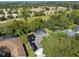 Aerial view showcasing a house with solar panels, a pool, and its location within a residential community at 372 Hinsdale Dr, Debary, FL 32713