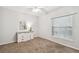 Well-lit bedroom with carpeted floors, ceiling fan, and dresser at 372 Hinsdale Dr, Debary, FL 32713