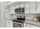 White cabinets and stainless steel appliances at 372 Hinsdale Dr, Debary, FL 32713