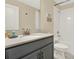 Clean bathroom with tub and shower, gray vanity, and white tile at 453 Ocean Course Ave, Champions Gate, FL 33896