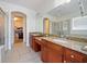 Double vanity bathroom with granite countertops and large mirror at 11826 Aurelio Ln, Orlando, FL 32827