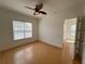 Bright bedroom with hardwood floors, ceiling fan, and access to private bath at 7465 Excitement Dr, Reunion, FL 34747