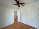 Bedroom with hardwood floors, double door closet and ceiling fan at 7465 Excitement Dr, Reunion, FL 34747