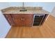 Wet bar with granite countertop, sink, and wine cooler at 7465 Excitement Dr, Reunion, FL 34747