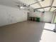 Spacious two-car garage featuring overhead storage and extra room at 7465 Excitement Dr, Reunion, FL 34747