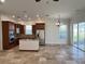 Open kitchen with island, stainless steel appliances, and wood cabinets at 7465 Excitement Dr, Reunion, FL 34747