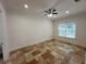 Bright bedroom with tile floors, ceiling fan and window with blinds at 7465 Excitement Dr, Reunion, FL 34747