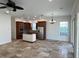 Open kitchen with island, stainless steel appliances, and wood cabinets at 7465 Excitement Dr, Reunion, FL 34747