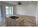 Kitchen with island, stainless steel appliances, and view to backyard at 7465 Excitement Dr, Reunion, FL 34747