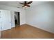 Bedroom featuring hardwood floors, a ceiling fan, and an ensuite bathroom at 7465 Excitement Dr, Reunion, FL 34747