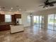 Open kitchen with island, stainless steel appliances, and wood cabinets at 7465 Excitement Dr, Reunion, FL 34747