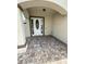Covered entryway with brick pavers leading to the front door at 7465 Excitement Dr, Reunion, FL 34747